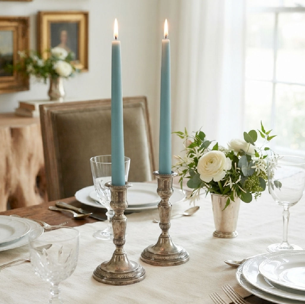 Aqua Ocean hand dipped taper candles glowing in elegant antique silver candlesticks