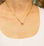 Heirloom charm keeper necklace in gold on model with white shirt