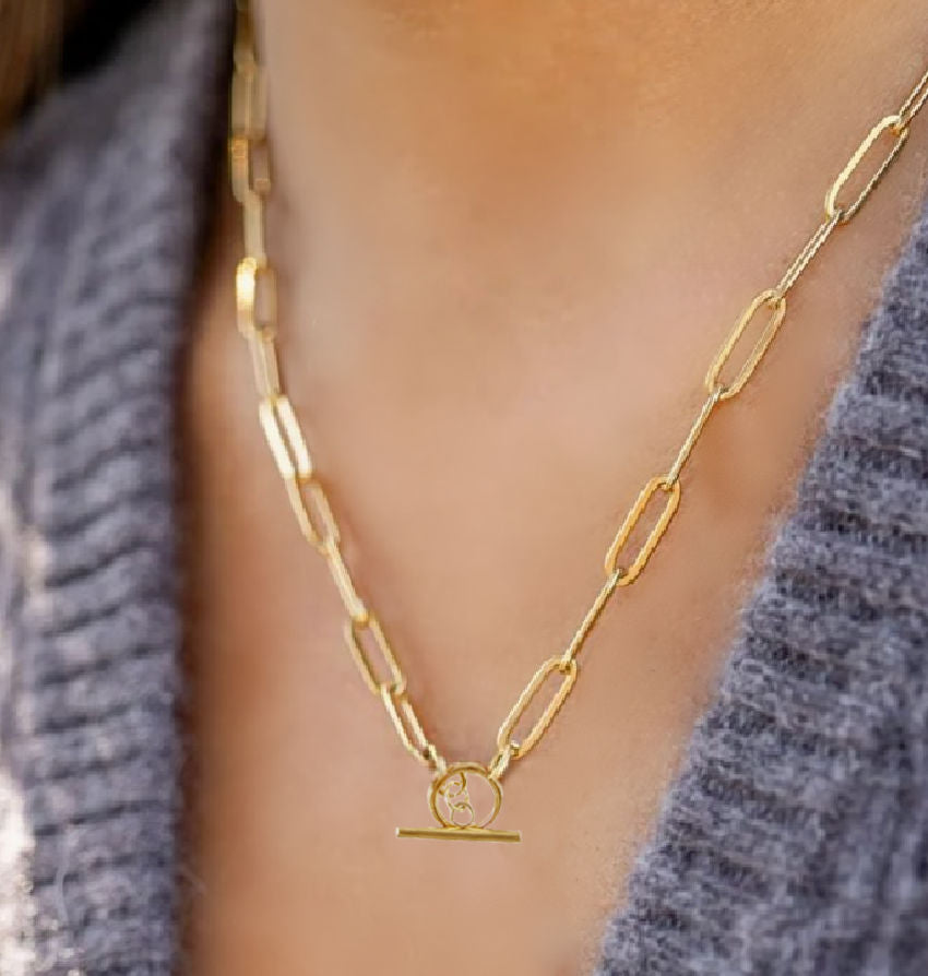 18K gold over stainless steel chunky paperclip necklace draped elegantly, showcasing luxury craftsmanship and timeless design
