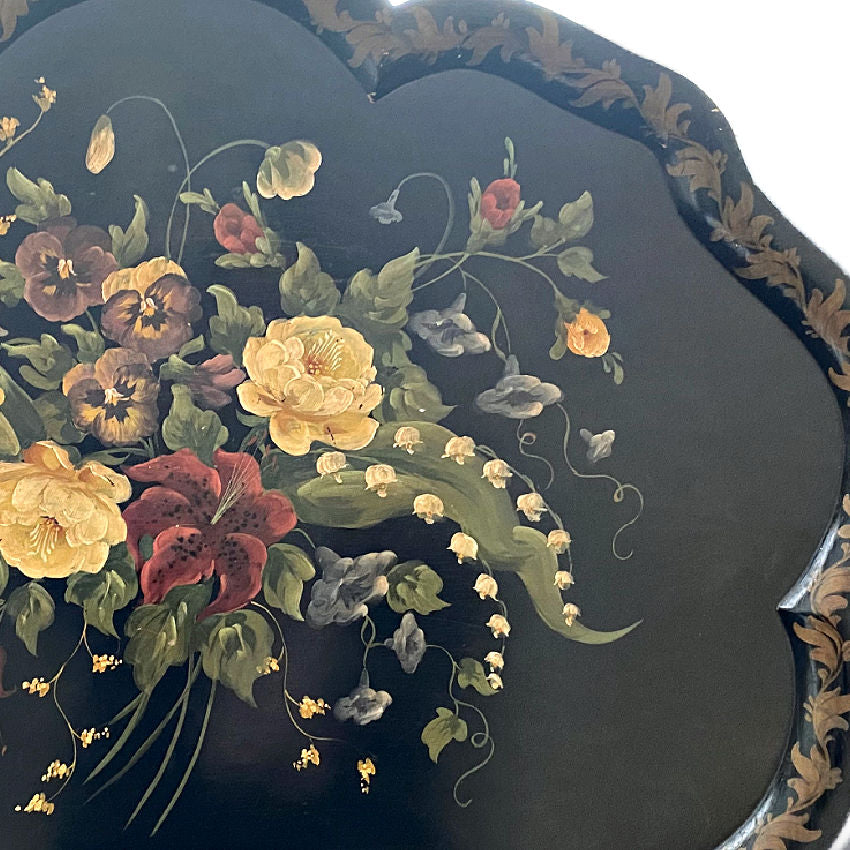 antique wooden tole tray showing surface texture and hand painting detail.