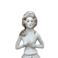 Antique porcelain half doll with Marie Antoinette-style hair, white color, and no visible markings.