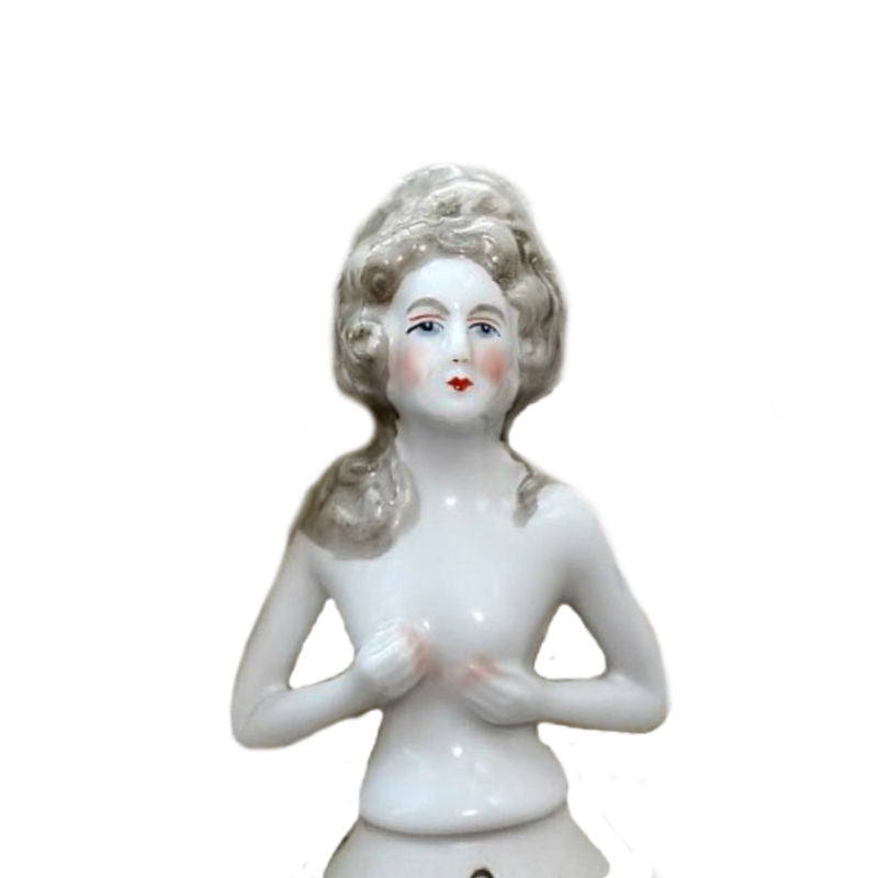 Antique porcelain half doll with Marie Antoinette-style hair, white color, and no visible markings.
