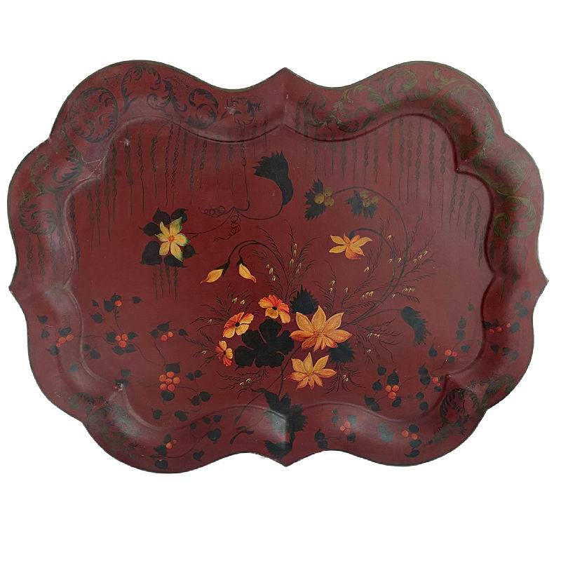 A large 19th century English tole tray in wine red with hand painted floral design, featuring a classic Chippendale shape with a central floral bouquet and surrounding leafy patterns.