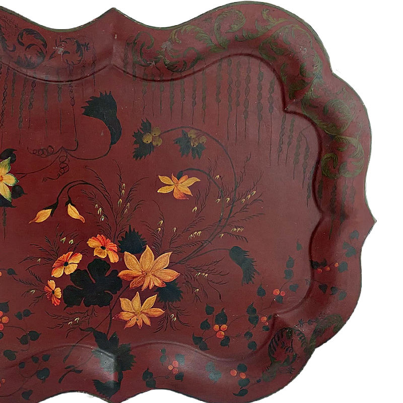Scalloped edge of antique English Red toleware tray with flowers black and gilt details