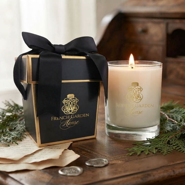 Les Bois FrenchGardenHouse candle with signature gift box displayed on an antique wood desk