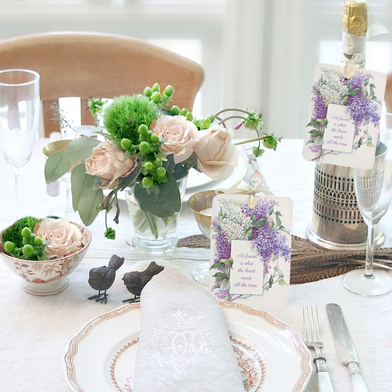 Elegant floral place cards on linen cardstock on a table setting and as a wine bottle tag.