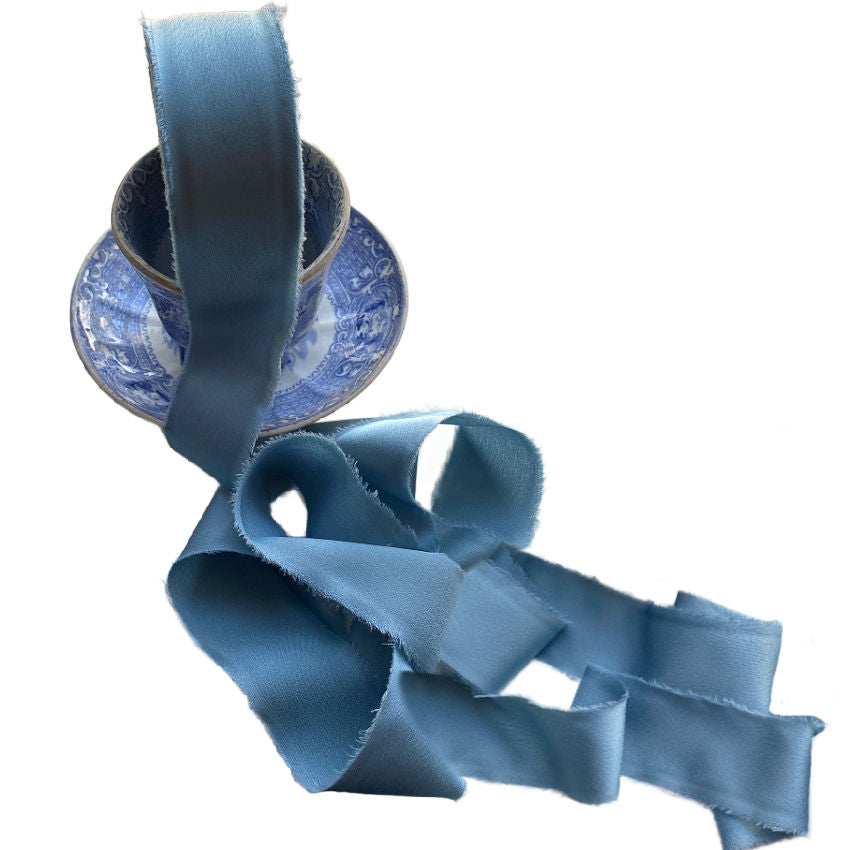 Luxurious silk-feel ribbon in Bleu Céleste. 1½" wide × 25 yards, soft and supple, perfect for gift wrapping, floral projects, and decorative accents.
