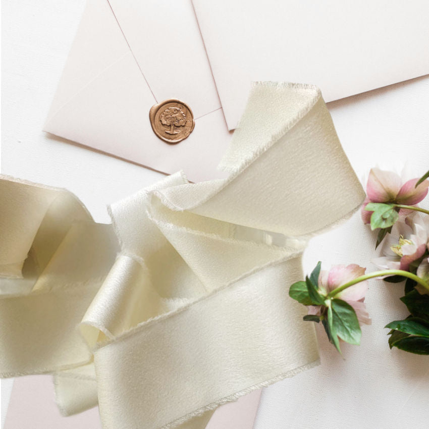 Luxurious silk-feel ribbon in Chantilly Cream. 1½" wide × 25 yards, soft and supple, perfect for gift wrapping, couture projects, and decorative accents.