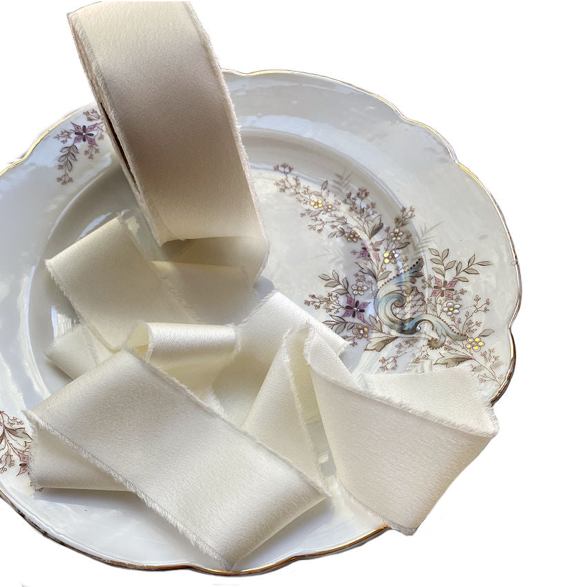 Luxurious silk-feel ribbon in Chantilly Cream. 1½" wide × 25 yards, soft and supple, perfect for gift wrapping, couture projects, and decorative accents.