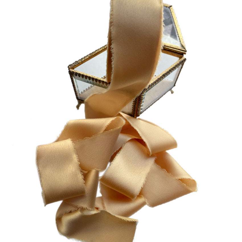 Luxurious silky ribbon in Lumière Dorée evoking sunlight and warmth. 1½" wide × 25 yards, soft and supple, perfect for gift wrapping, couture projects, and decorative accents.
