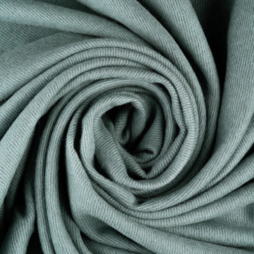 Indulge in this handwoven Celadon Mist alpaca throw, crafted from the finest baby alpaca for unmatched softness, warmth, and timeless sophistication.