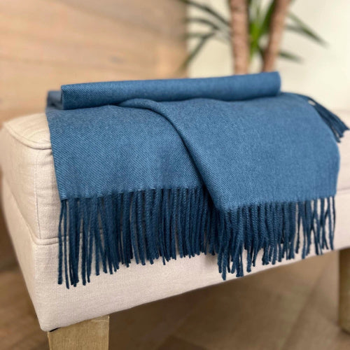 Indulge in this handwoven Slate Indigo alpaca throw, crafted from the finest baby alpaca for unmatched softness, warmth, and timeless sophistication.