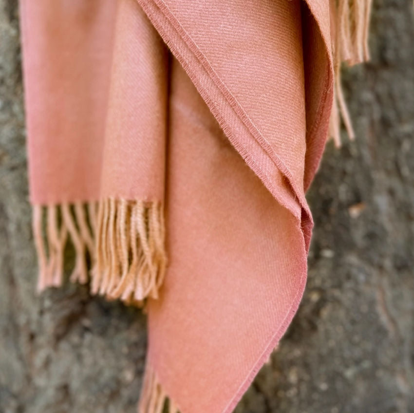 Indulge in this handwoven persimmon alpaca throw, crafted from the finest baby alpaca fiber for exceptional softness, warmth, and timeless luxury.