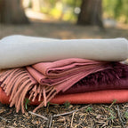 Indulge in this handwoven persimmon alpaca throw, crafted from the finest baby alpaca fiber for exceptional softness, warmth, and timeless luxury.