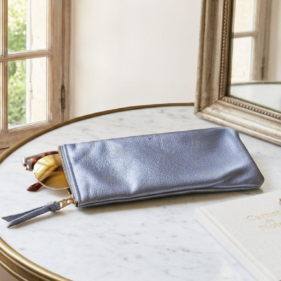Elyse Hydrangea leather eyeglass case on marble table with sunglasses