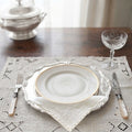 Madeira hand embroidered white linen placemats and napkins elegantly styled on a French dining table