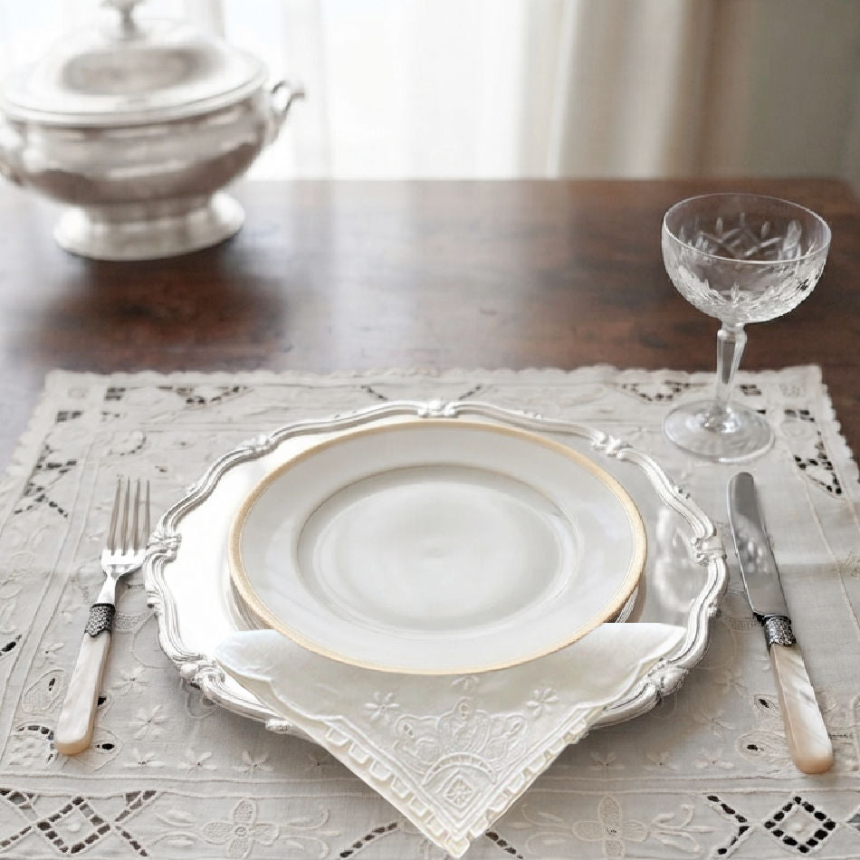 Madeira hand embroidered white linen placemats and napkins elegantly styled on a French dining table