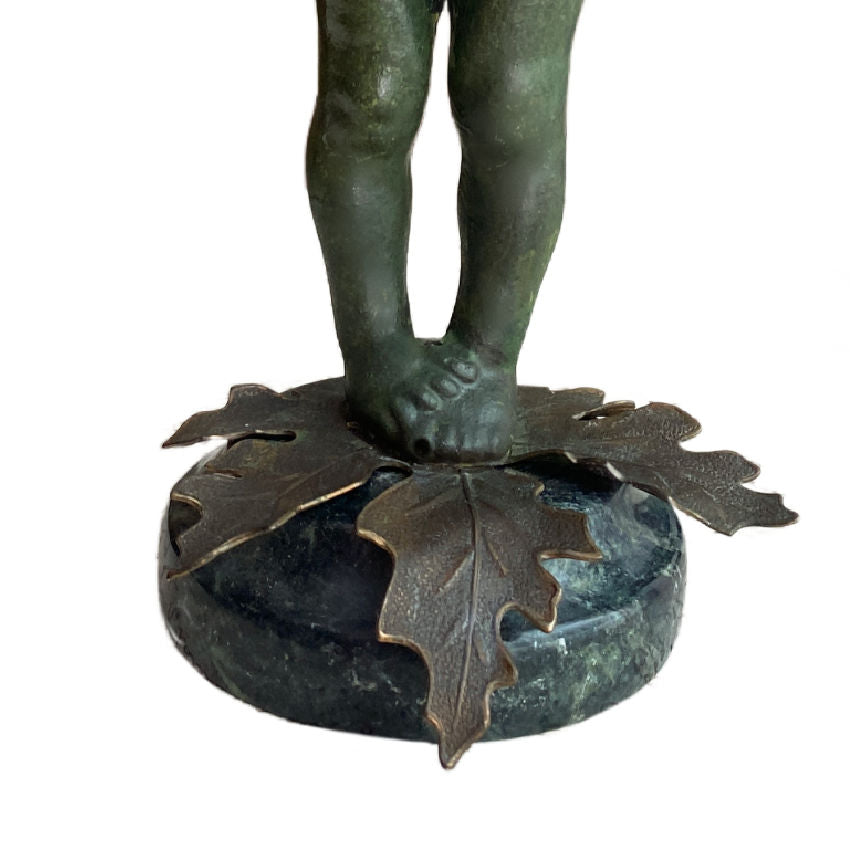 Rear view unmarked figural object showing surface patina and age