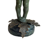 Rear view unmarked figural object showing surface patina and age