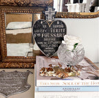 Display of mid-century French Sacred Heart plaque among antiques, with modern art in gold frame and rose and decorator books