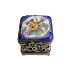 Top detail of hand painted Limoges blue box with gilt bow closure, musical instruments and roses 