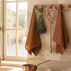 Cognac linen tea towel hung in a French country kitchen over the sink