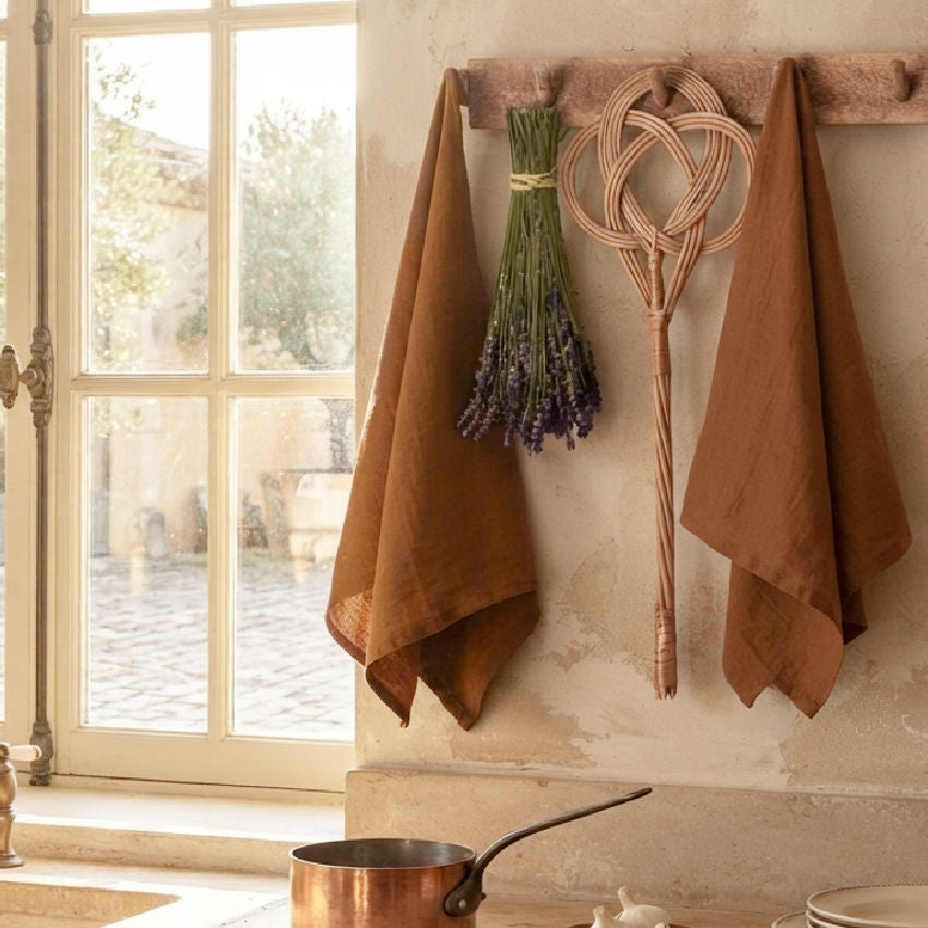 Cognac linen tea towel hung in a French country kitchen over the sink