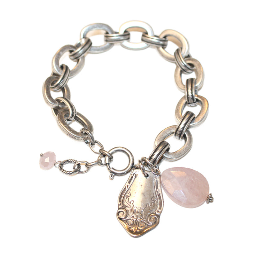 Antique sterling silver bracelet with a floral charm and a rose quartz dangle.