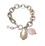 Antique sterling silver bracelet with a floral charm and a rose quartz dangle.