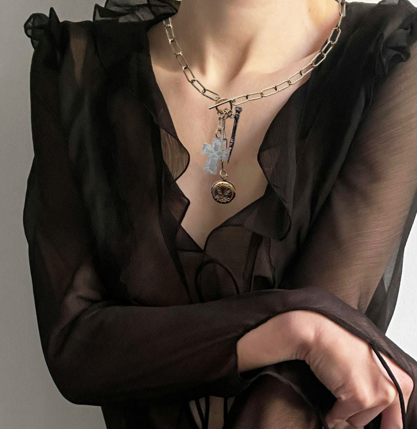 Antique gold filled locket necklace with a Victorian chatelaine pencil and a carved mother-of-pearl cross on a paper clip chain.