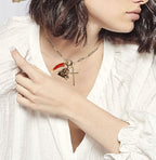 Gold cross, watch fob ad carnelian stone charm necklace on paper lip chain