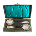 A charming pair of antique silver-plated jam spoons, monogrammed “D” and hand-engraved with rococo shell and leaf motifs. In their original case, increasingly difficult to find and perfect for elegant tables.