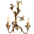 Close-up detail of hand-painted lily flowers on vintage French wall lights