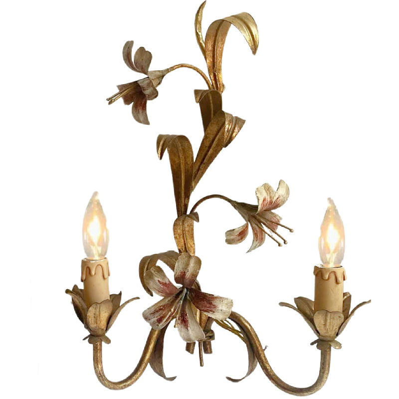 Close-up detail of hand-painted lily flowers on vintage French wall lights