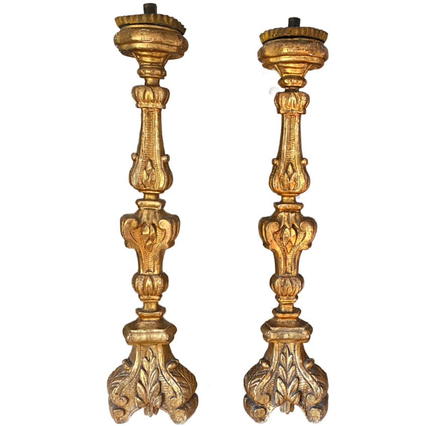 Large 19th-century French gilt altar candlesticks in complementary sizes with gilded fronts. Elegant and luminous, perfect for mantels or luxury interiors.