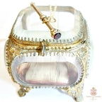Antique gold and garnet chatelaine pencil necklace on antique French jewelry casket
