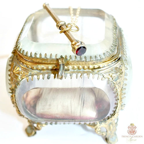 Antique gold and garnet chatelaine pencil necklace on antique French jewelry casket