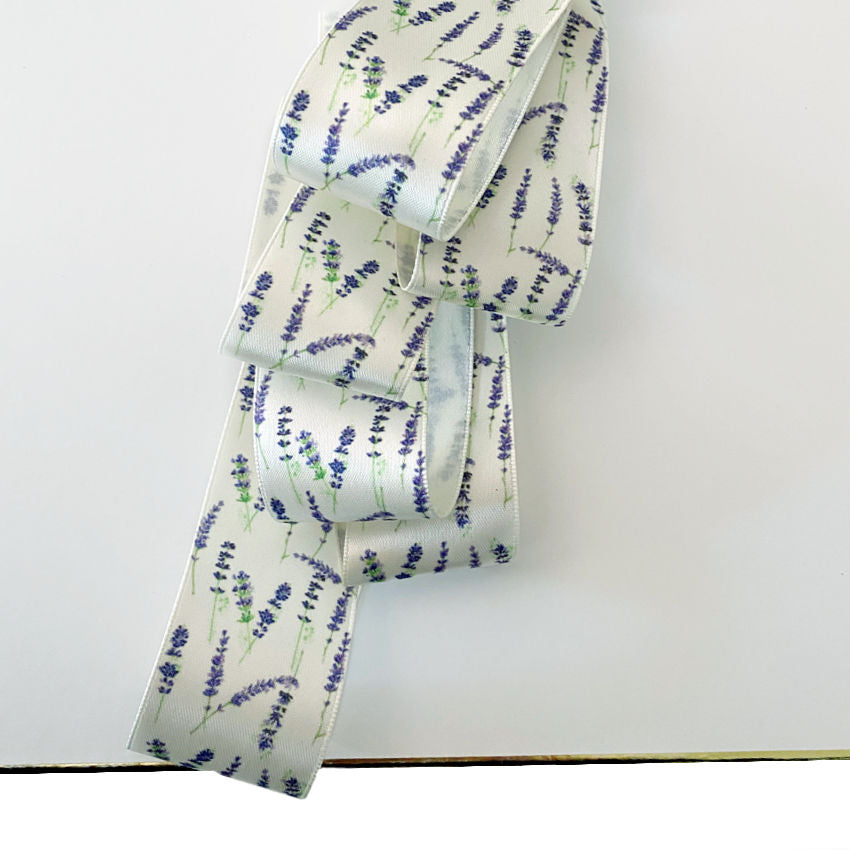 White satin ribbon embellished with lavender flowers for luxury gift wrapping