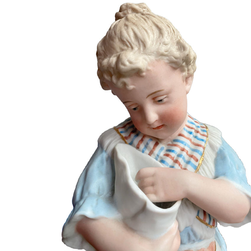 Rare matched pair of antique Gebrüder Heubach bisque figurines of a girl and boy enjoying sweets. Exquisite German craftsmanship, circa 1900.