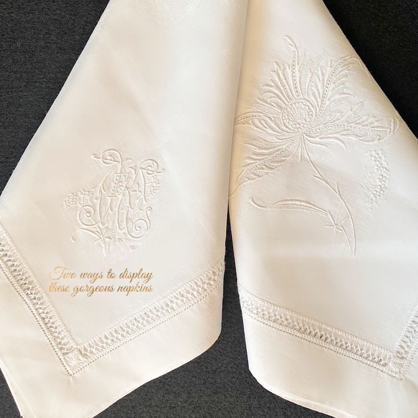 Close view of delicate white hand embroidery on antique French linen