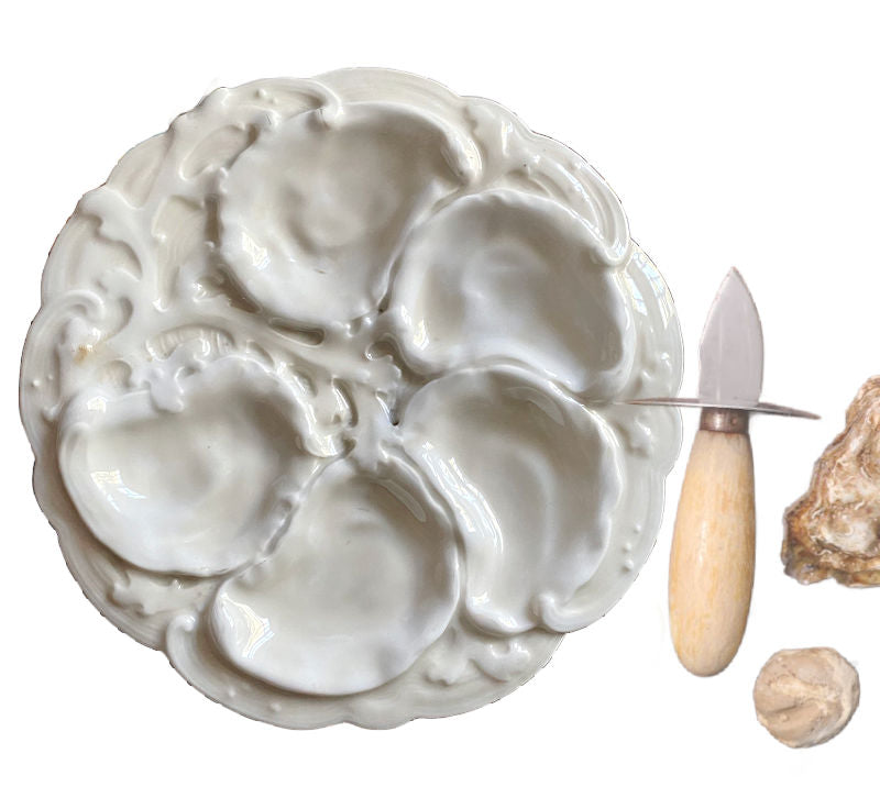 Rare 19th century French Limoges oyster plate in all-white relief porcelain. Elegant antique French tableware for collectors and refined display.
