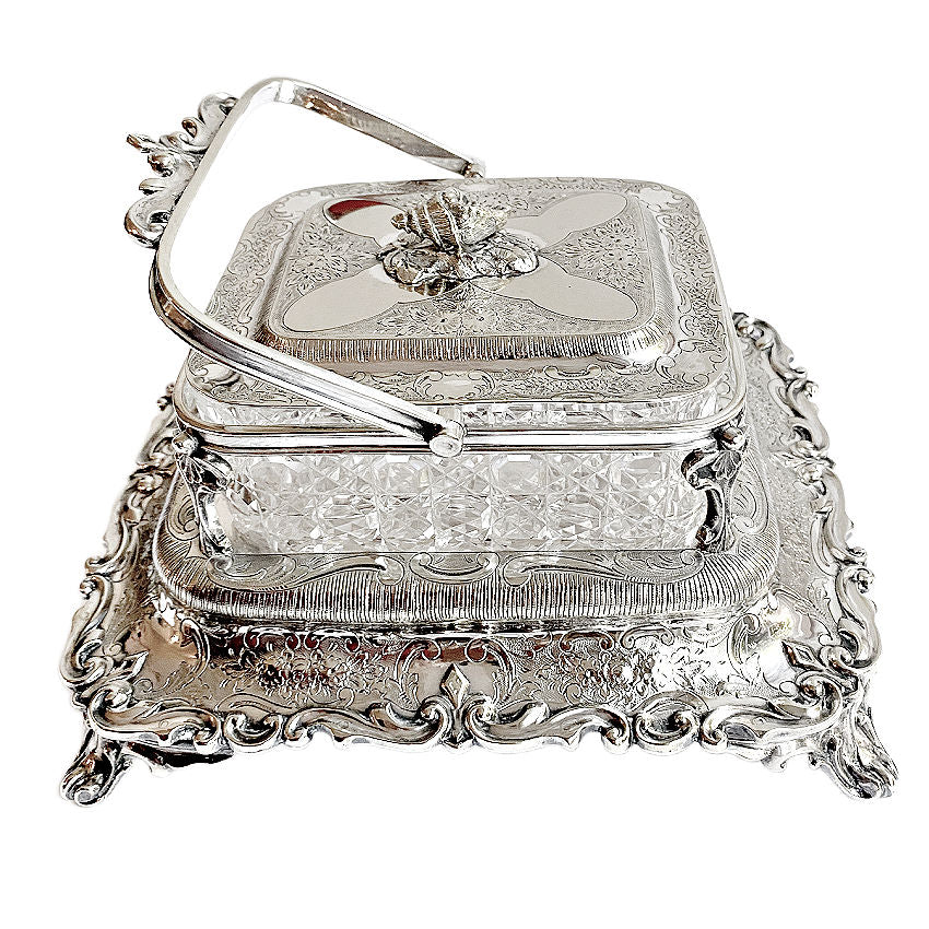
Ornate antique Mappin &amp; Webb silver-plated sardine server with cut crystal liner and scrolled feet. A rare, collectible English tableware piece.