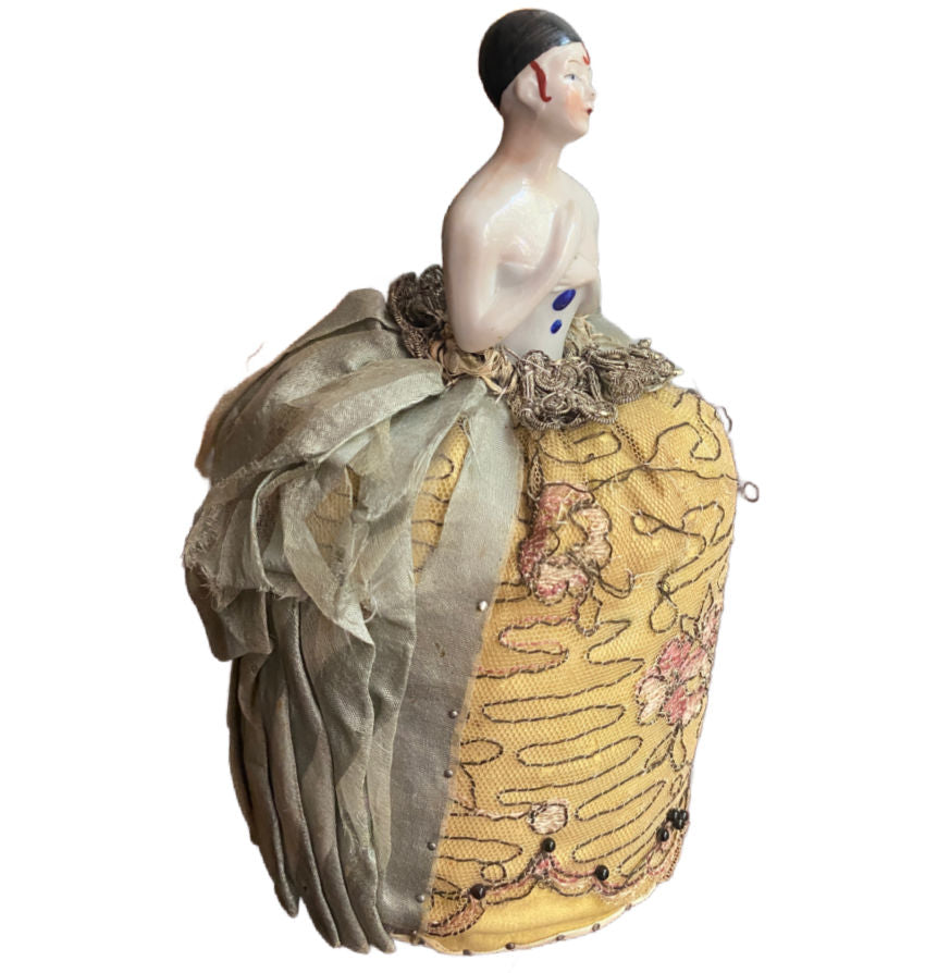 Collectible early 20th century boudoir doll with silk costume and silver ribbon waist side view