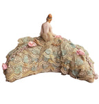 collectible bisque doll with delicate painted face and lace trimmed half moon cushion base back view