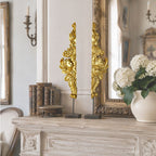 Antique French gilt gesso angel fragments displayed on a mantel in a French country living room