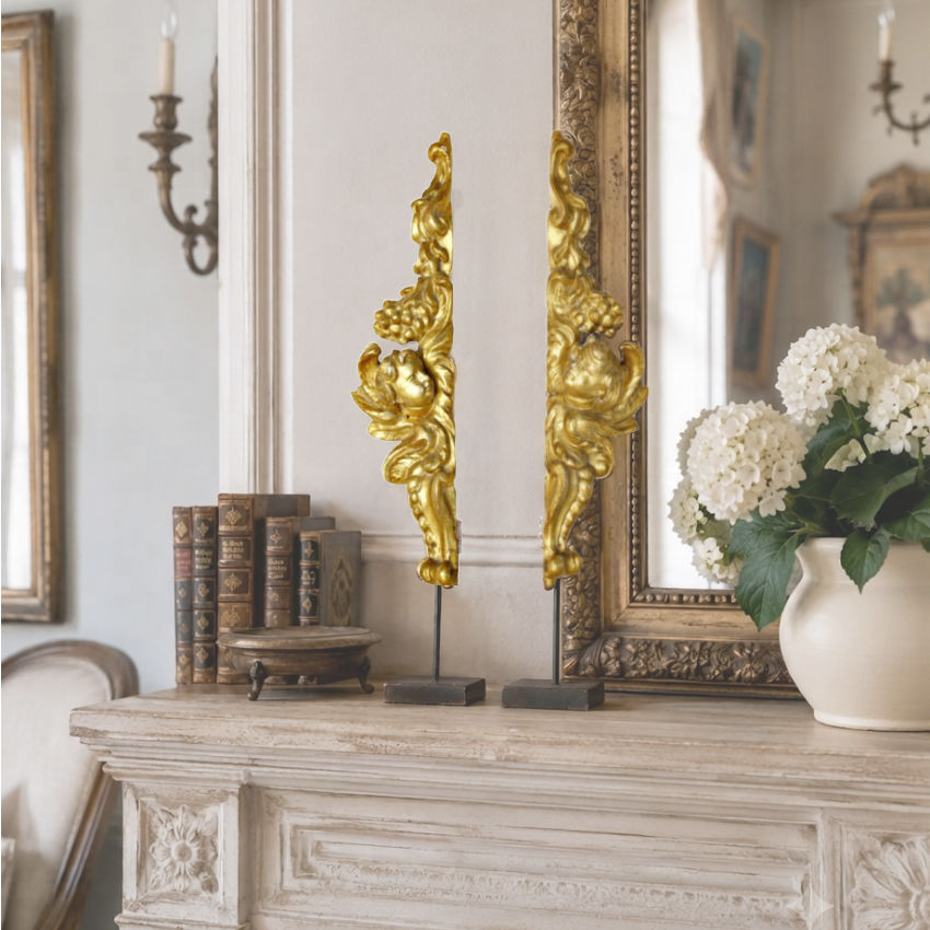 Antique French gilt gesso angel fragments displayed on a mantel in a French country living room