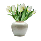 Long a symbol of love, this real touch faux tulip bouquet in white features lifelike petals and lush green leaves for timeless floral elegance.