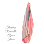 Lightweight alpaca wool blanket in warm pink and neutral shades