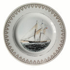 Detail of gilt rim framing vintage-style sailing ship illustration on porcelain