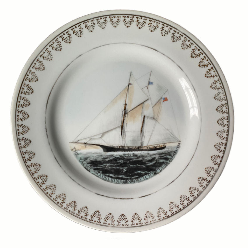Detail of gilt rim framing vintage-style sailing ship illustration on porcelain